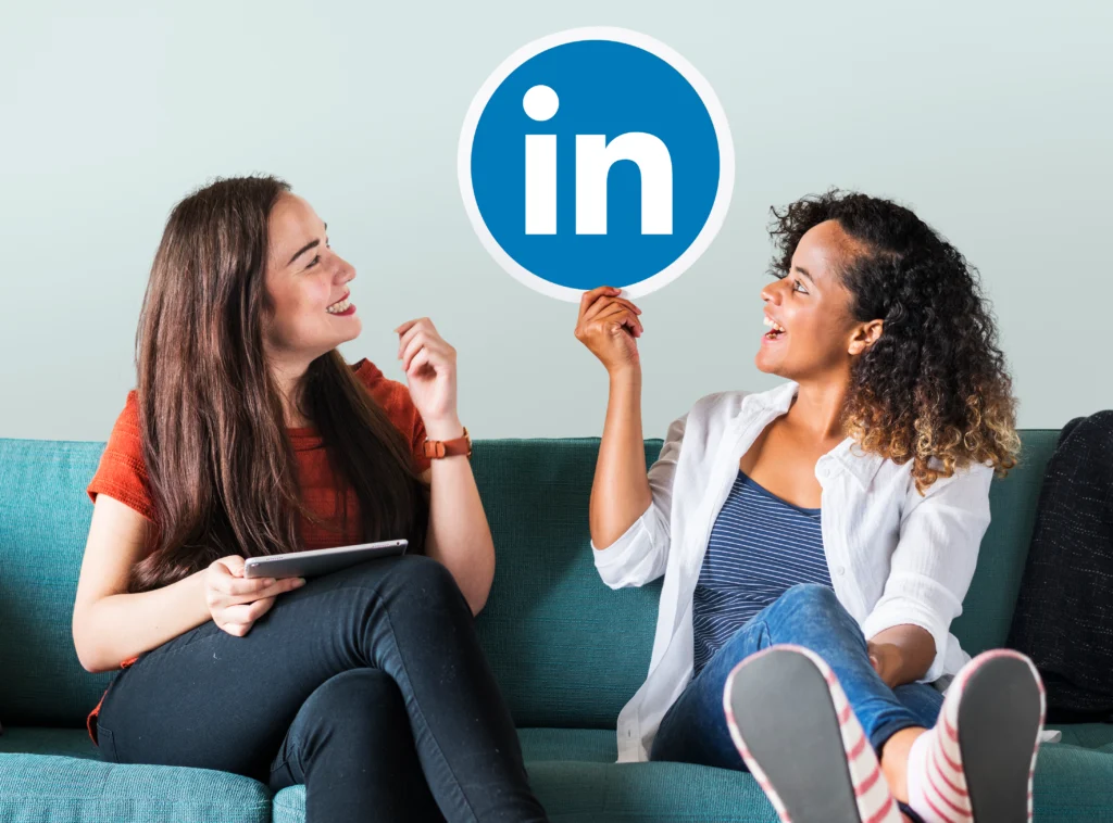 women-holding-linkedin-logo linkdin